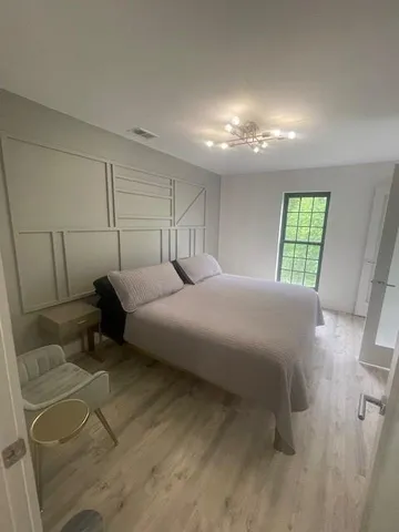 a bedroom with a bed and a window