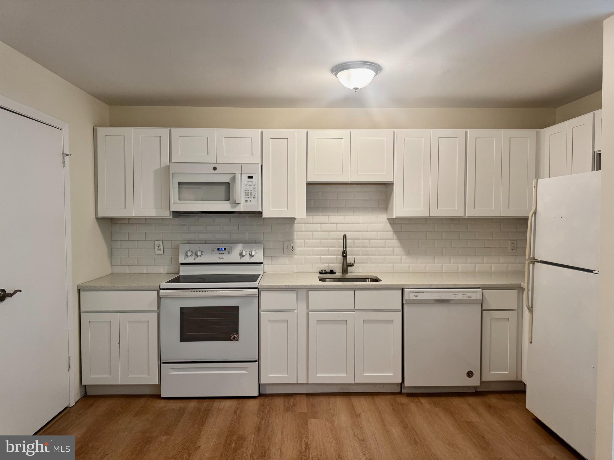 8 Winners Circle, Unit 2B Owings Mills, MD 21117 - Photo 5 of 14 a kitchen with stainless steel appliances granite countertop a stove a sink and white cabinets