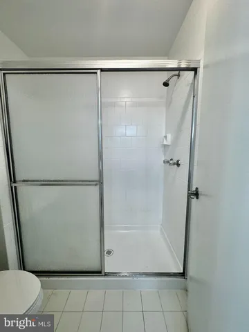 a view of a room with wooden floor and a glass door