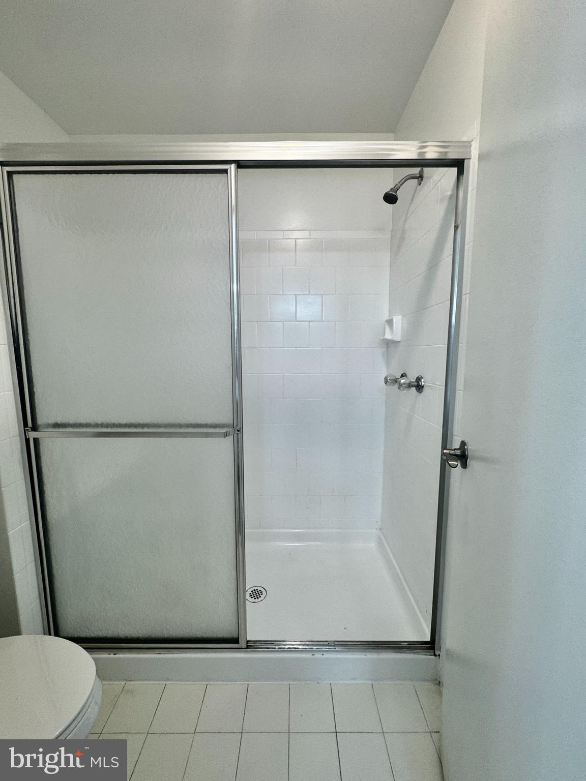 8 Winners Circle, Unit 2B Owings Mills, MD 21117 - Photo 10 of 14 a view of a room with wooden floor and a glass door