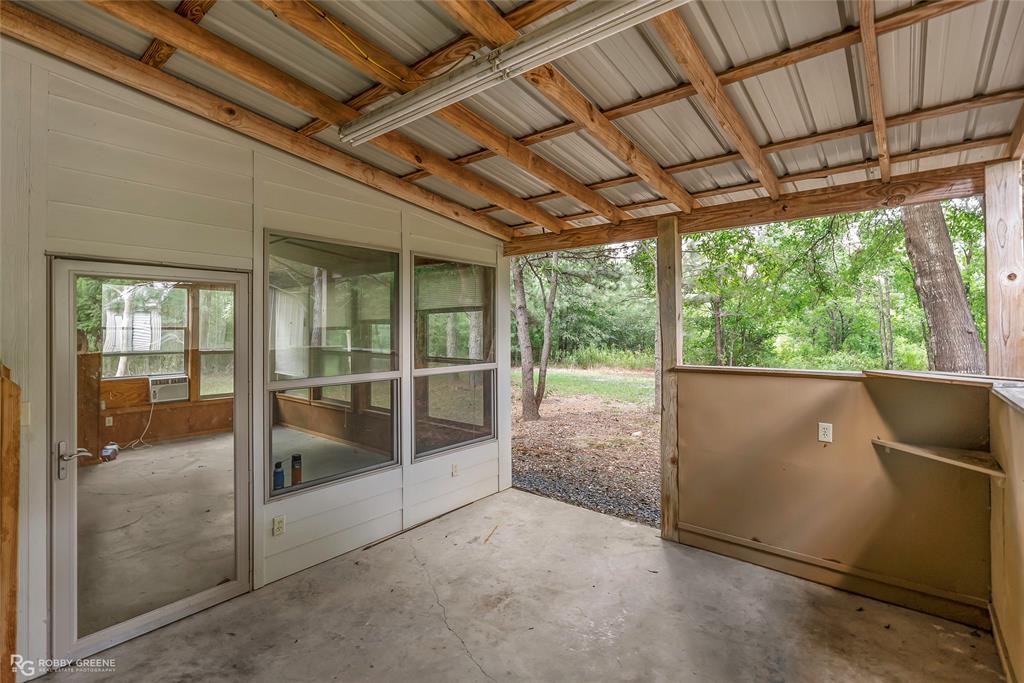 209 Addison Road Mansfield, LA 71052 - Photo 21 of 25 Unfurnished sunroom with a patio area and lofted ceiling