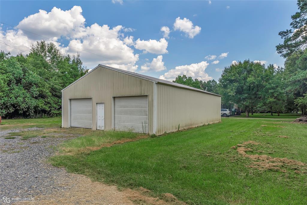 209 Addison Road Mansfield, LA 71052 - Photo 24 of 25 Detached garage with view of wooded area