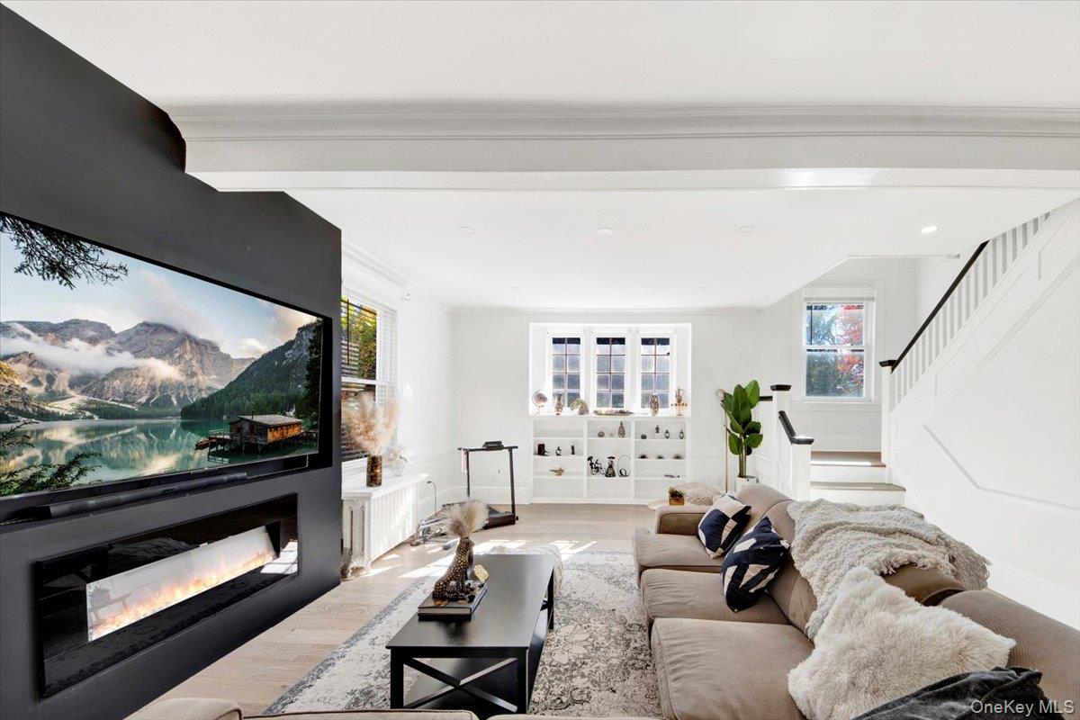 1 Slocum Street New Rochelle, NY 10801 - Photo 17 of 49 a living room with furniture flat screen tv and a fireplace
