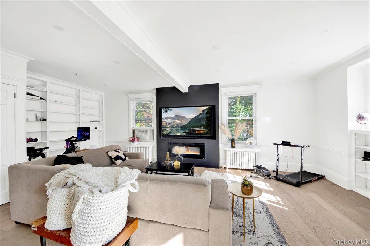 1 Slocum Street New Rochelle, NY 10801 - Photo 18 of 49 a living room with furniture floor to ceiling window and a flat screen tv