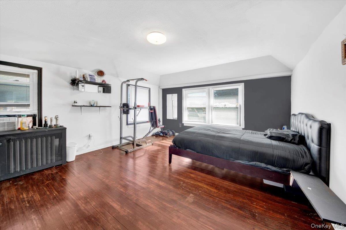 1 Slocum Street New Rochelle, NY 10801 - Photo 21 of 49 a bedroom with a bed and wooden floor