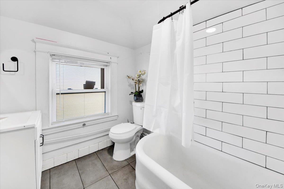 1 Slocum Street New Rochelle, NY 10801 - Photo 23 of 49 a bathroom with a bathtub and a toilet