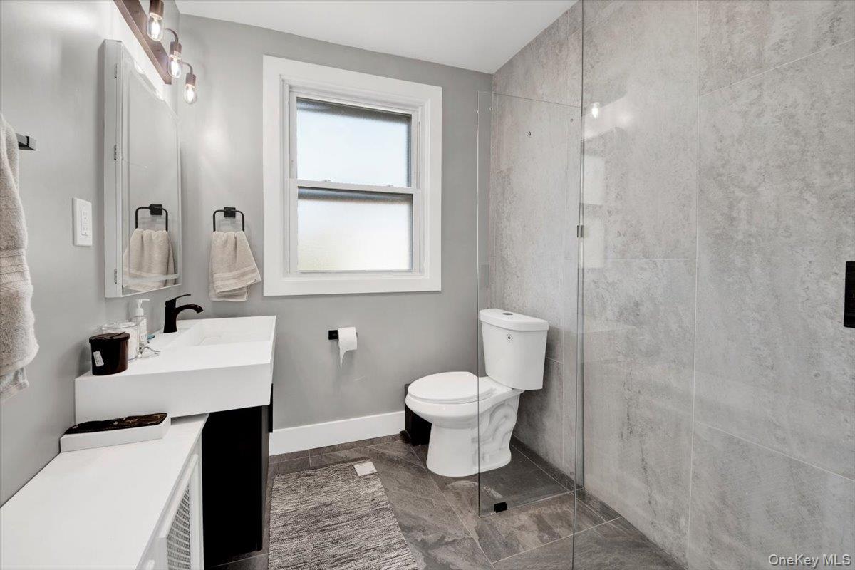 1 Slocum Street New Rochelle, NY 10801 - Photo 26 of 49 a bathroom with a sink toilet and mirror