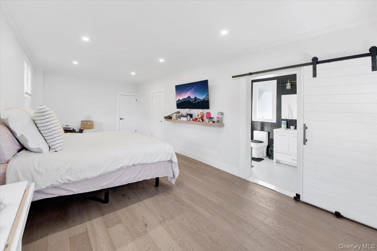 1 Slocum Street New Rochelle, NY 10801 - Photo 28 of 49 a spacious bedroom with a bed and a flat screen tv