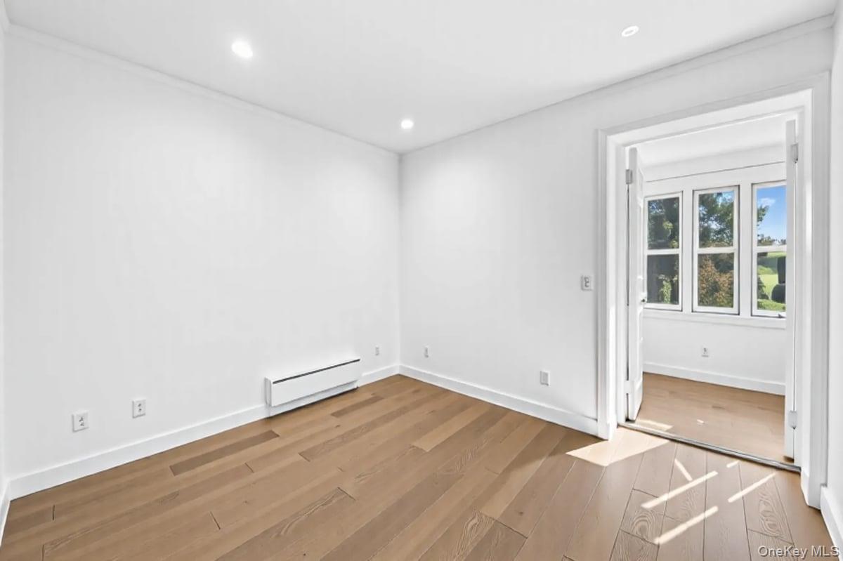 1 Slocum Street New Rochelle, NY 10801 - Photo 32 of 49 an empty room with wooden floor and windows