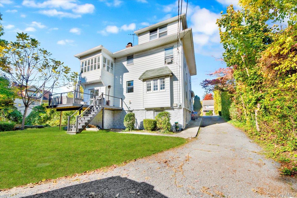 1 Slocum Street New Rochelle, NY 10801 - Photo 42 of 49 a front view of a house with garden and trees