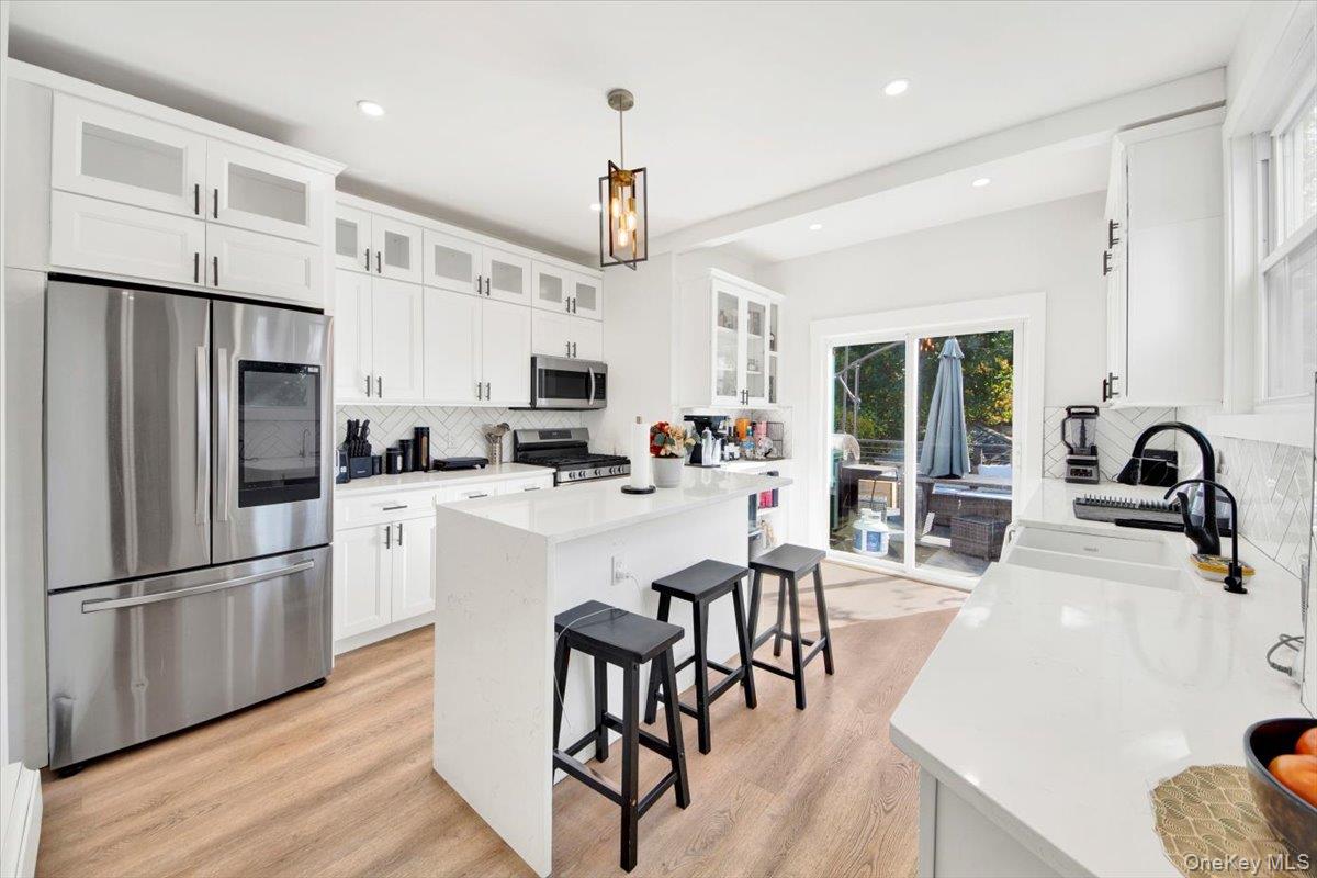 1 Slocum Street New Rochelle, NY 10801 - Photo 5 of 49 a kitchen with refrigerator a sink and chairs