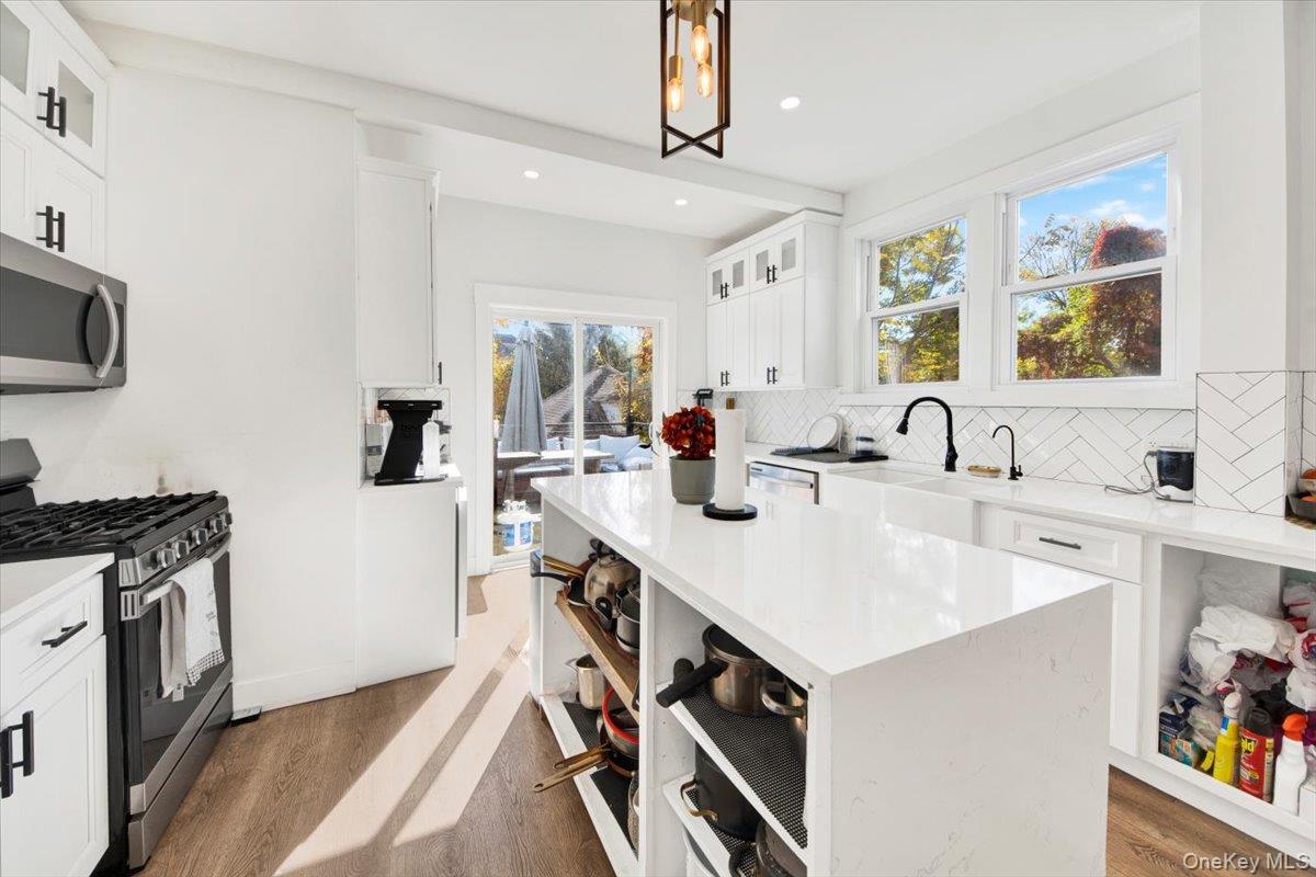 1 Slocum Street New Rochelle, NY 10801 - Photo 7 of 49 a kitchen with a sink a stove and a wooden floor