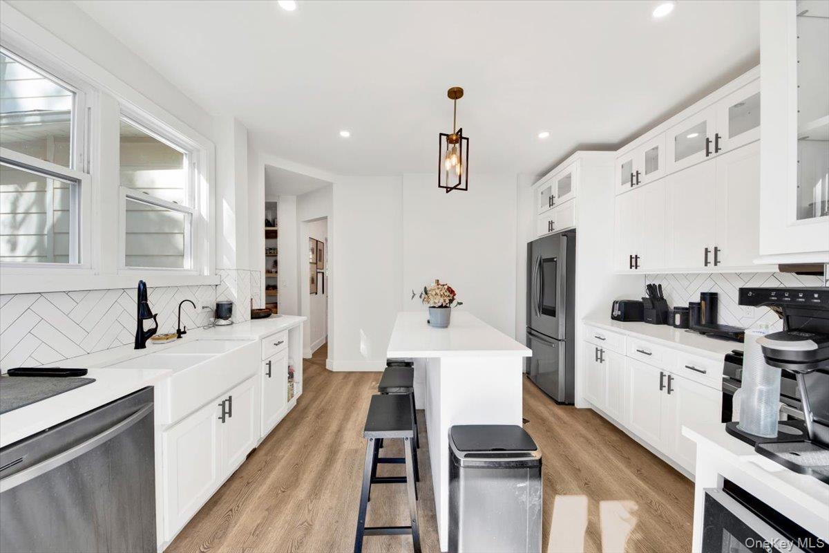 1 Slocum Street New Rochelle, NY 10801 - Photo 8 of 49 a large white kitchen with stainless steel appliances sink a stove and white cabinets