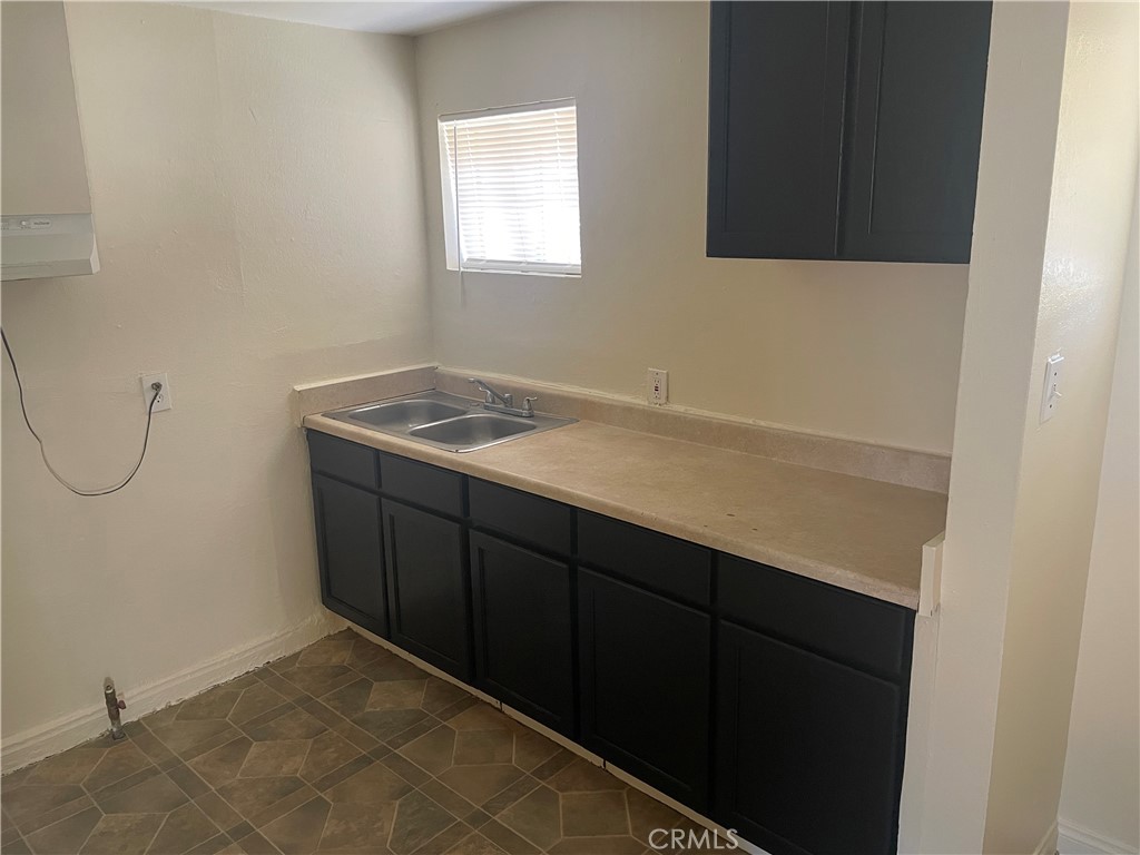 8343 Trey Avenue, Unit A Riverside, CA 92503 - Photo 5 of 17 a room with a sink cabinets and a window