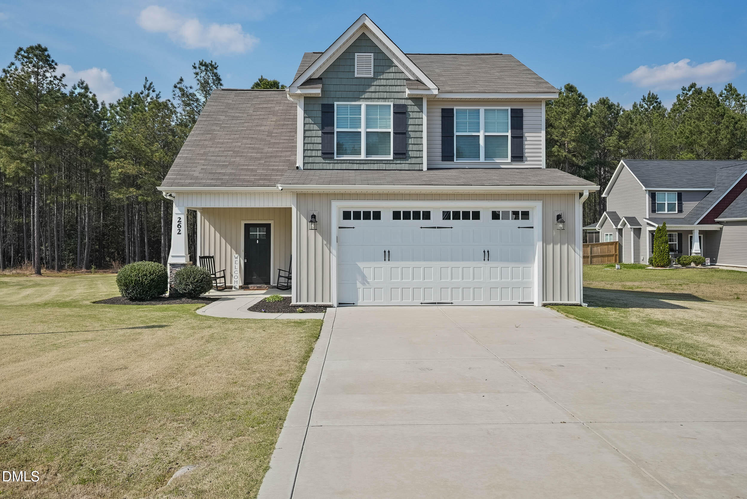 a view of house with outdoor space and parking area