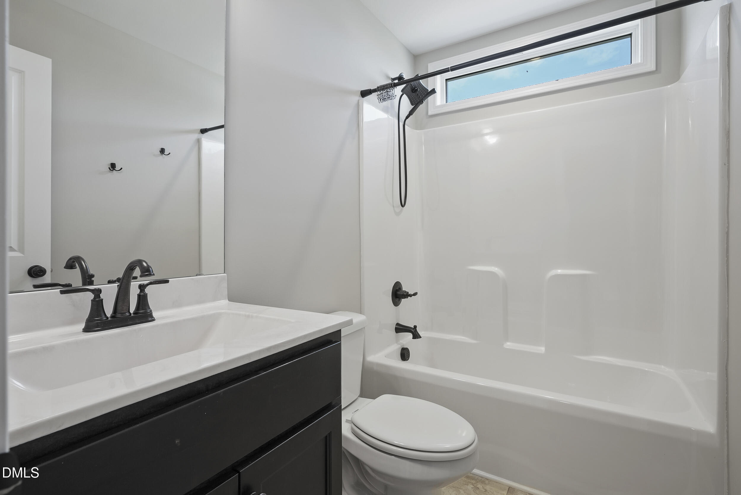 262 Day Lily Street Selma, NC 27576 - Photo 19 of 39 a bathroom with a sink a toilet a mirror and shower