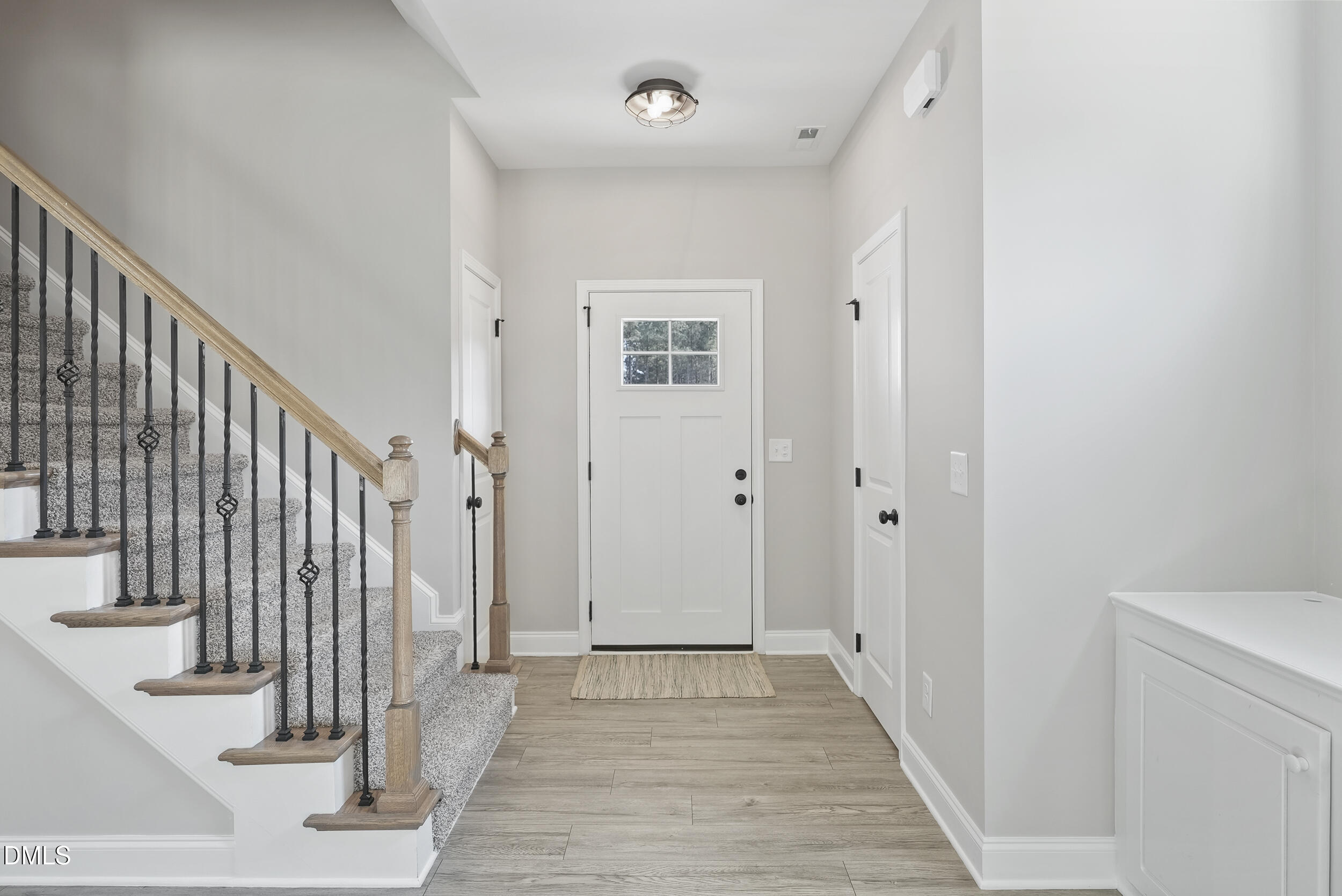 262 Day Lily Street Selma, NC 27576 - Photo 3 of 39 a view of a hallway with wooden floor and entryway