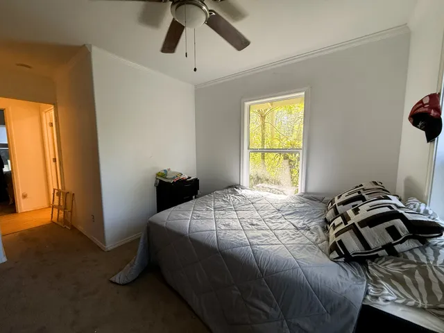 a bedroom with a bed and a window