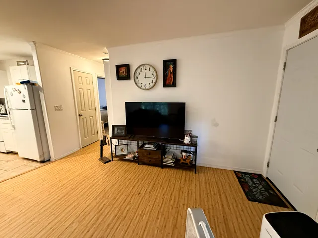 a view of a livingroom with furniture and a flat screen tv