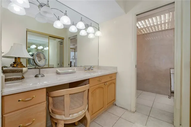 a bathroom with a granite countertop sink a mirror and a shower