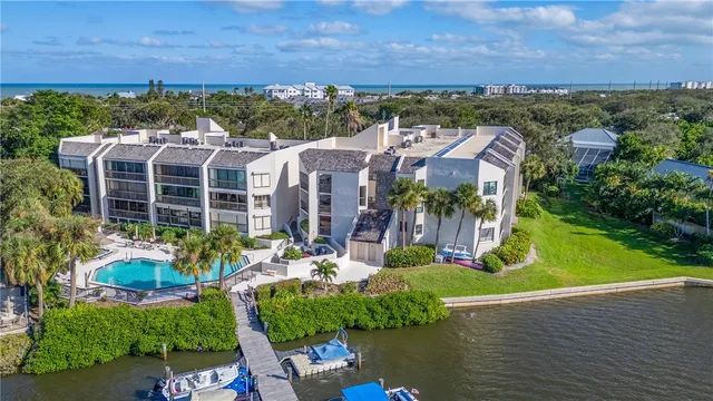 an aerial view of a house with a yard potted plants and large tree