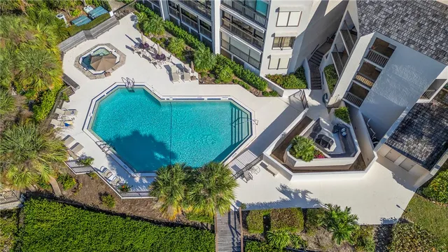 an aerial view of a house with a garden and trees