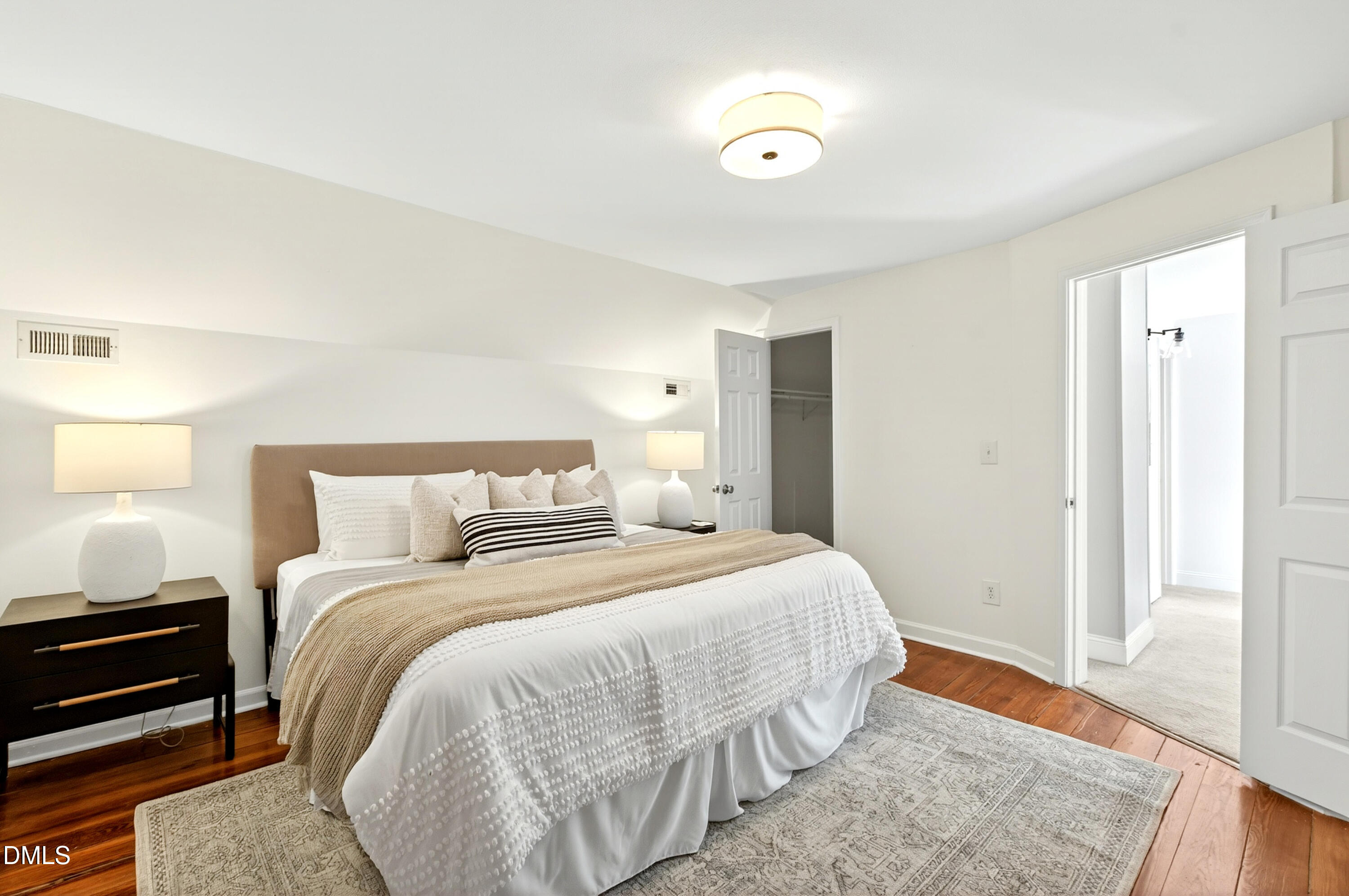 913 Washington Street Durham, NC 27701 - Photo 20 of 37 a bedroom with a bed and wooden floor