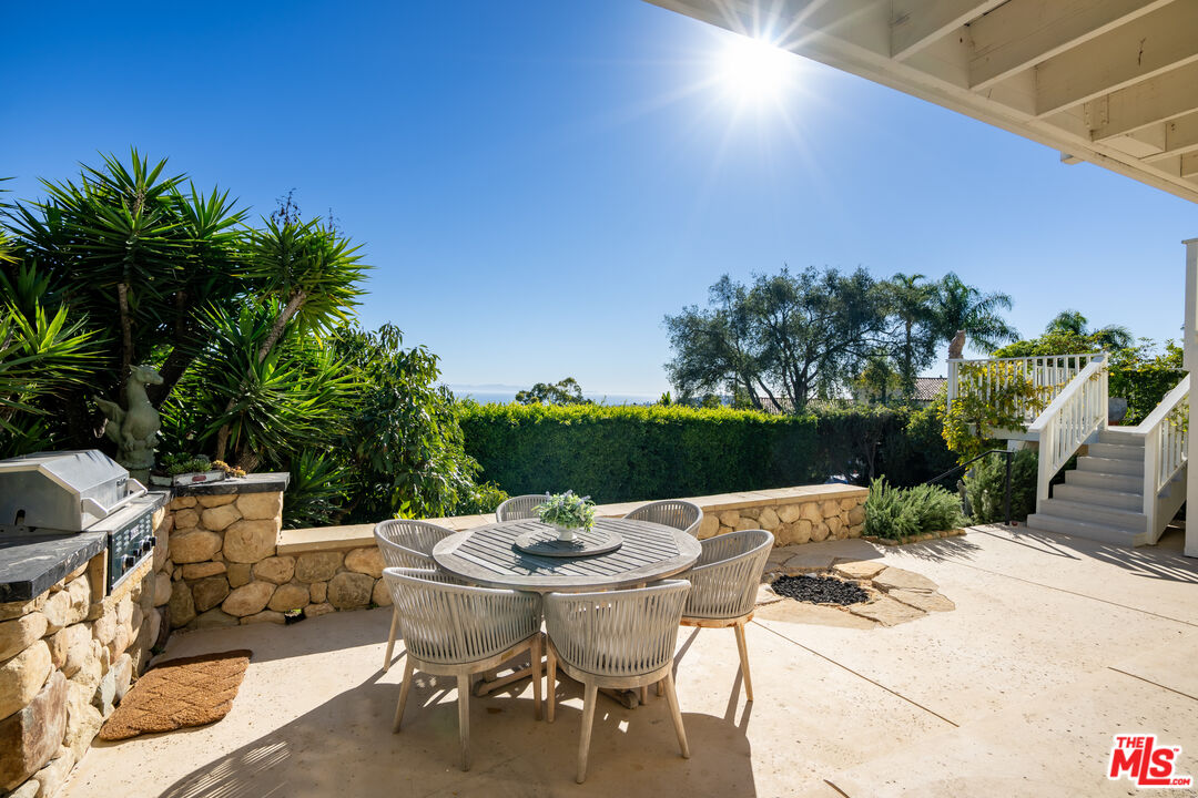 624 Las Alturas Road Santa Barbara, CA 93103 - Photo 16 of 22 a view of a patio with table and chairs potted plants with wooden fence