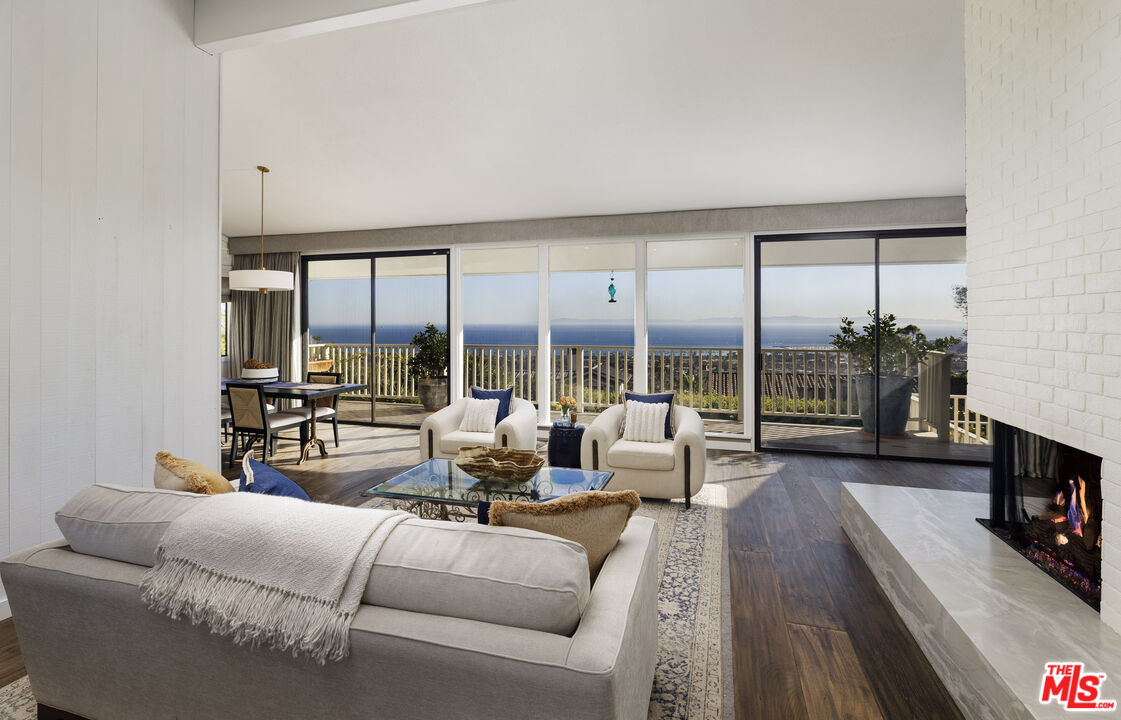 624 Las Alturas Road Santa Barbara, CA 93103 - Photo 3 of 22 a living room with furniture large windows and a flat screen tv