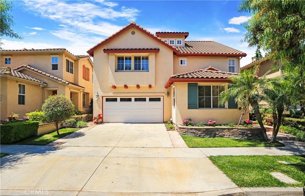 14 Ravendale Irvine, CA 92602 - Photo 3 of 13 a front view of a house with a yard and potted plants