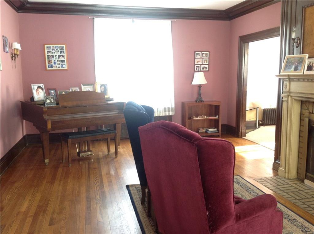 Living Room:  Original hard wood floors with a picture window on both sides to allow for natural lighting to come in.  