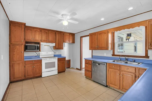 a kitchen with stainless steel appliances granite countertop a stove sink and cabinets
