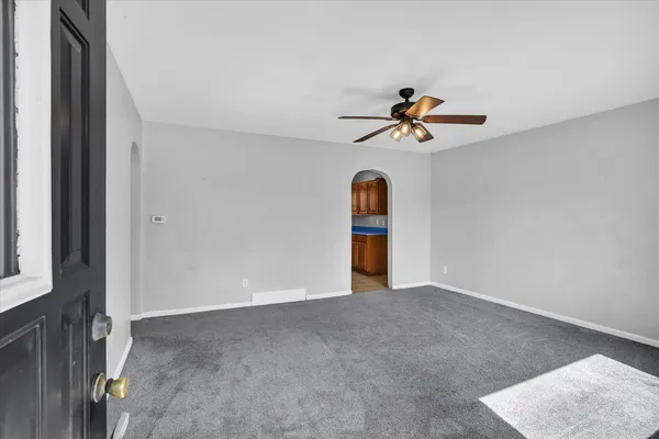 a view of a room with a ceiling fan and a chandelier fan