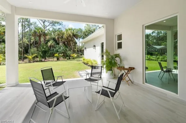a patio with yard glass top table and chairs