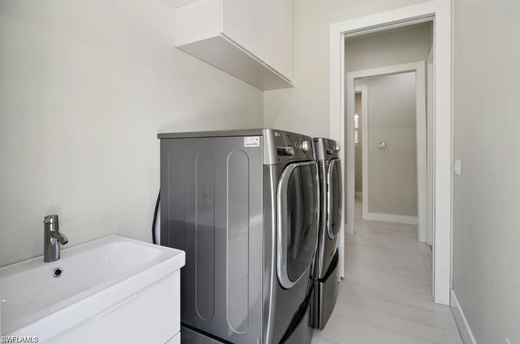 3740 3rd Avenue Southwest Naples, FL 34117 - Photo 12 of 16 Washroom featuring separate washer and dryer and baseboards