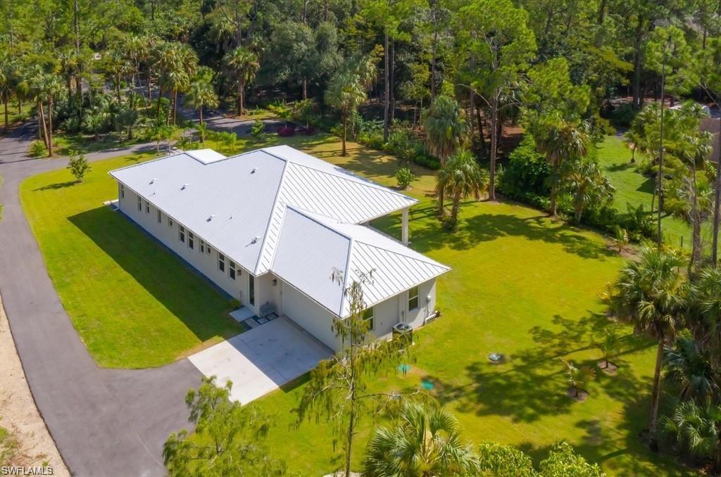 3740 3rd Avenue Southwest Naples, FL 34117 - Photo 15 of 16 Aerial view of property and surrounding area featuring a tree filled landscape