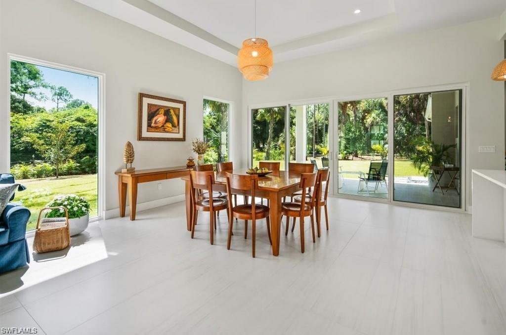 3740 3rd Avenue Southwest Naples, FL 34117 - Photo 6 of 16 Dining room with plenty of natural light and a raised ceiling