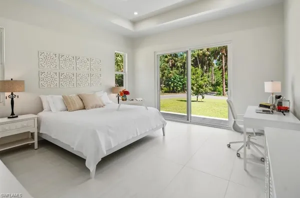 a spacious bedroom with a bed and a table