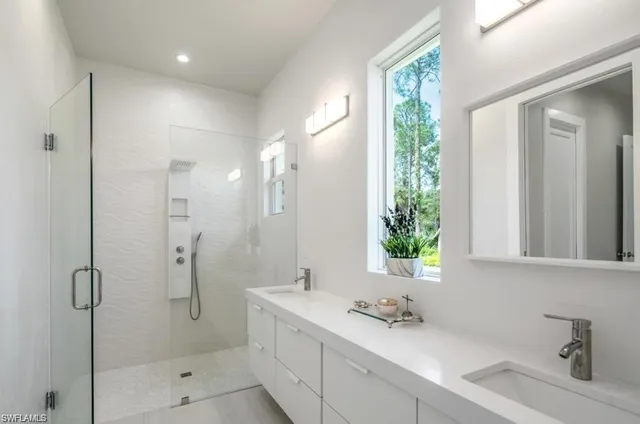 a bathroom with a shower sink and mirror
