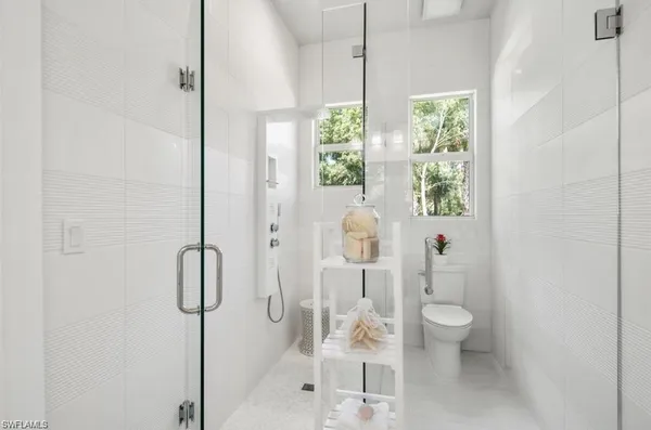 a bathroom with a bathtub shower sink and toilet