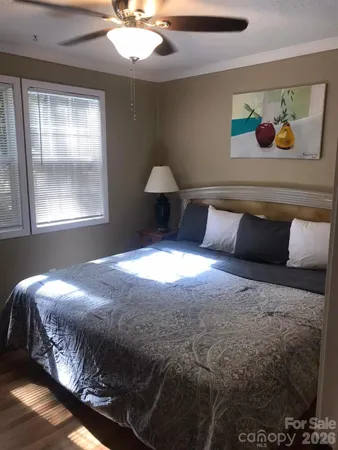 a bedroom with a bed and a painting on the wall