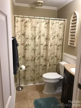 a bathroom with a toilet and a shower