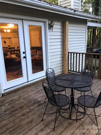 a view of a chairs and table in the balcony