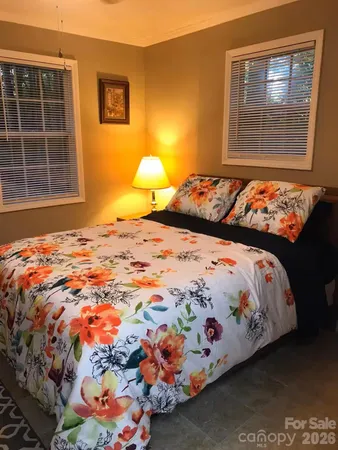 a bedroom with a bed and window