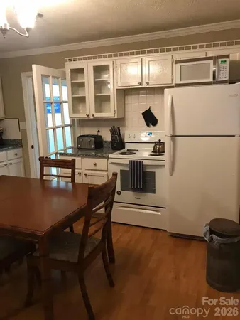 a kitchen with a stove a sink and a refrigerator