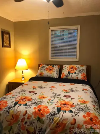 a bedroom with a bed and lamp