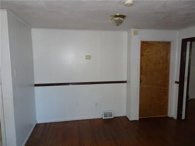 a view of walk in closet with wooden floor