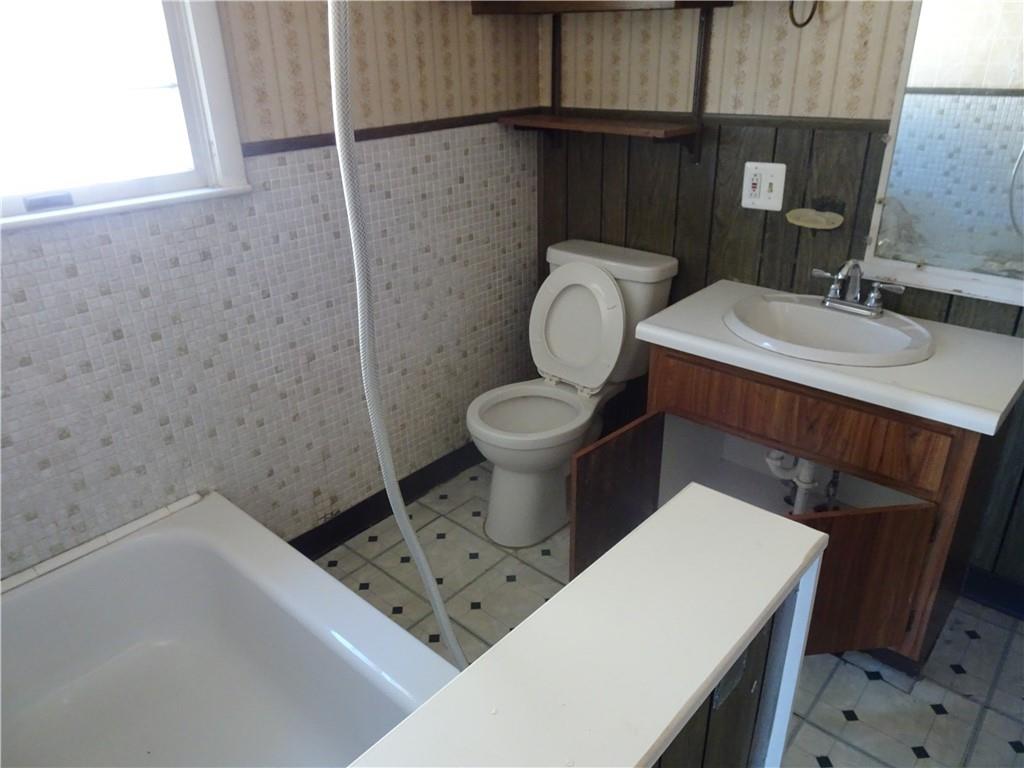 227 South 6th Street Youngwood, PA 15697 - Photo 15 of 27 a bathroom with a sink a toilet and a mirror