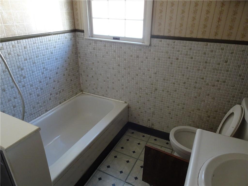 227 South 6th Street Youngwood, PA 15697 - Photo 16 of 27 a bathroom with a tub and a window