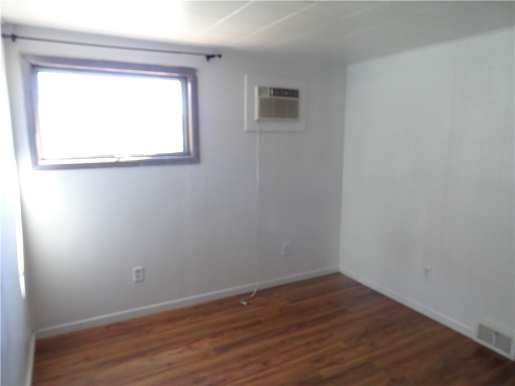 227 South 6th Street Youngwood, PA 15697 - Photo 19 of 27 a view of an empty room with wooden floor and a window